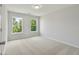 Spacious bedroom with neutral walls, carpet, and two bright windows at 2802 Lacy St, North Charleston, SC 29406