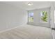 Bright bedroom with neutral walls and carpet, and two windows at 2802 Lacy St, North Charleston, SC 29406