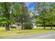 Brick and white ranch house with a carport and mature trees at 978 Independent School Rd, Reevesville, SC 29471