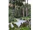 Landscaped front yard with lush greenery and a curved driveway at 3325 Hopkinson Plantation Rd, Johns Island, SC 29455