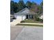 Gray house with a two-car garage and well-maintained lawn at 129 Thistle Rd, Goose Creek, SC 29445