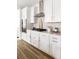 Modern kitchen with white cabinets, stainless steel appliances, and quartz countertops at 424 Grove End Rd, Moncks Corner, SC 29461