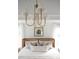 Main bedroom with a cane headboard, neutral bedding, and a chandelier at 424 Grove End Rd, Moncks Corner, SC 29461