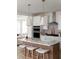 Modern kitchen with white cabinets, quartz countertops, and an island with seating at 424 Grove End Rd, Moncks Corner, SC 29461