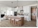 Modern kitchen with white cabinets, quartz countertops, and an island with seating at 424 Grove End Rd, Moncks Corner, SC 29461