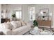 Light and airy living room with a beige sofa and stylish coffee table at 424 Grove End Rd, Moncks Corner, SC 29461
