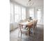 Bright dining room with a wood table, six chairs, and large windows at 424 Grove End Rd, Moncks Corner, SC 29461