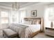 Main bedroom with wood bed frame, neutral bedding, and stylish decor at 424 Grove End Rd, Moncks Corner, SC 29461