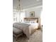 Main bedroom with a cane headboard, neutral bedding, and a bench at the foot of the bed at 424 Grove End Rd, Moncks Corner, SC 29461