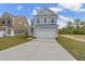 Two-story Craftsman home with gray siding, white trim, and a two-car garage at 424 Grove End Rd, Moncks Corner, SC 29461