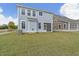 Two-story house with gray siding, screened porch, and a green lawn at 424 Grove End Rd, Moncks Corner, SC 29461