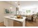 Modern kitchen island with white cabinets and stainless steel appliances at 7426 Indigo Palms Way, Johns Island, SC 29455