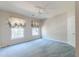 Bright bedroom with two windows, light-blue carpet, and a ceiling fan at 1431 Belcourt Ln, Mount Pleasant, SC 29466