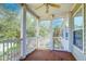 Relaxing screened porch with ceiling fan, offering a view of the lush greenery at 1431 Belcourt Ln, Mount Pleasant, SC 29466