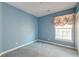 Light blue bedroom with window and neutral carpeting at 1431 Belcourt Ln, Mount Pleasant, SC 29466