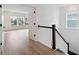 Upstairs hallway with hardwood floors, staircase, and access to bedrooms at 1679 Siloh Dr # 494, Mount Pleasant, SC 29466