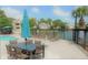 Relaxing pool area with patio furniture, umbrella, and pond view at 1481 Center Extension St # 208, Mount Pleasant, SC 29464