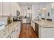 Modern kitchen with granite countertops, white cabinets, and stainless steel appliances at 304 Weston Hall Dr, Summerville, SC 29483