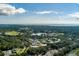 Aerial view showcasing condo building 1640, tennis courts, and water views at 1640 Live Oak Park, Seabrook Island, SC 29455