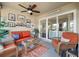 Relaxing sunroom with wicker seating, a ceiling fan, and access to balcony at 1640 Live Oak Park, Seabrook Island, SC 29455