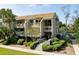 Two-story condo with multiple balconies, lush landscaping, and a walkway at 1640 Live Oak Park, Seabrook Island, SC 29455