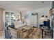 Bright living room with white sofa, blue accents, and a view to balcony at 1640 Live Oak Park, Seabrook Island, SC 29455
