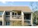 Second-story balcony with wicker chairs and a view of treetops at 1640 Live Oak Park, Seabrook Island, SC 29455