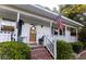 Charming white house with a welcoming front porch and American flag at 1351 Winifred St, Mount Pleasant, SC 29464