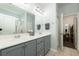 Double vanity bathroom with gray cabinets and a shower at 575 Rosings Dr, Summerville, SC 29486