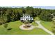 Two-story home with circular driveway and lush green lawn at 7848 Pelican Bay Dr, Awendaw, SC 29429