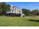 Two story home with balcony and landscaping at 7848 Pelican Bay Dr, Awendaw, SC 29429