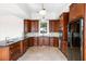 Kitchen boasts dark wood cabinets, granite countertops and tile flooring at 7848 Pelican Bay Dr, Awendaw, SC 29429