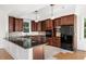 Kitchen with dark wood cabinets, granite counters, and stainless steel appliances at 7848 Pelican Bay Dr, Awendaw, SC 29429
