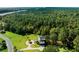 Aerial view of a house on a wooded lot near the water at 7848 Pelican Bay Dr, Awendaw, SC 29429