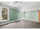 Serene bedroom with carpet flooring, soft green walls, and multiple windows at 7848 Pelican Bay Dr, Awendaw, SC 29429
