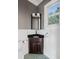 Dark vanity, black countertop and teal tile floor in small bathroom at 7848 Pelican Bay Dr, Awendaw, SC 29429