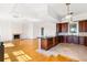 Open concept kitchen with island and breakfast area, hardwood floors at 7848 Pelican Bay Dr, Awendaw, SC 29429