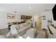 Bright living room featuring a beige couch, ottoman, and large TV at 175 Rosefield Ct, Summerville, SC 29485