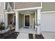 Inviting front entry with porch and seasonal decor at 175 Rosefield Ct, Summerville, SC 29485