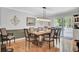 Elegant dining room with wood table, neutral decor, and hardwood floors at 205 Whitesville Rd, Moncks Corner, SC 29461