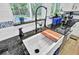Modern farmhouse kitchen sink with black faucet and butcher block cutting board at 205 Whitesville Rd, Moncks Corner, SC 29461