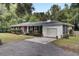 Brick ranch house with attached garage, landscaping, and a paved driveway at 205 Whitesville Rd, Moncks Corner, SC 29461
