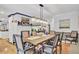 Spacious dining room featuring a long farmhouse table and hardwood floors at 205 Whitesville Rd, Moncks Corner, SC 29461