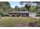 Brick ranch house with attached garage and manicured lawn at 205 Whitesville Rd, Moncks Corner, SC 29461