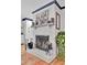 Fireplace with white brick surround, decorative screen, and mantle with artwork at 205 Whitesville Rd, Moncks Corner, SC 29461