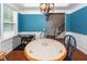 Bright dining room with a round table, chairs, and dog crate at 208 Sweetspire Ln, Summerville, SC 29483