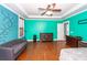Bright bedroom with teal walls, hardwood floors, and ample space at 208 Sweetspire Ln, Summerville, SC 29483