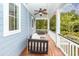 Relaxing covered porch featuring a ceiling fan and comfortable hanging swing with plush cushions at 208 Sweetspire Ln, Summerville, SC 29483