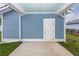 Covered patio with a blue exterior and white door at 208 Sweetspire Ln, Summerville, SC 29483