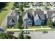 An aerial view of a charming home nestled between well-maintained lawns and tree-lined streets at 208 Sweetspire Ln, Summerville, SC 29483